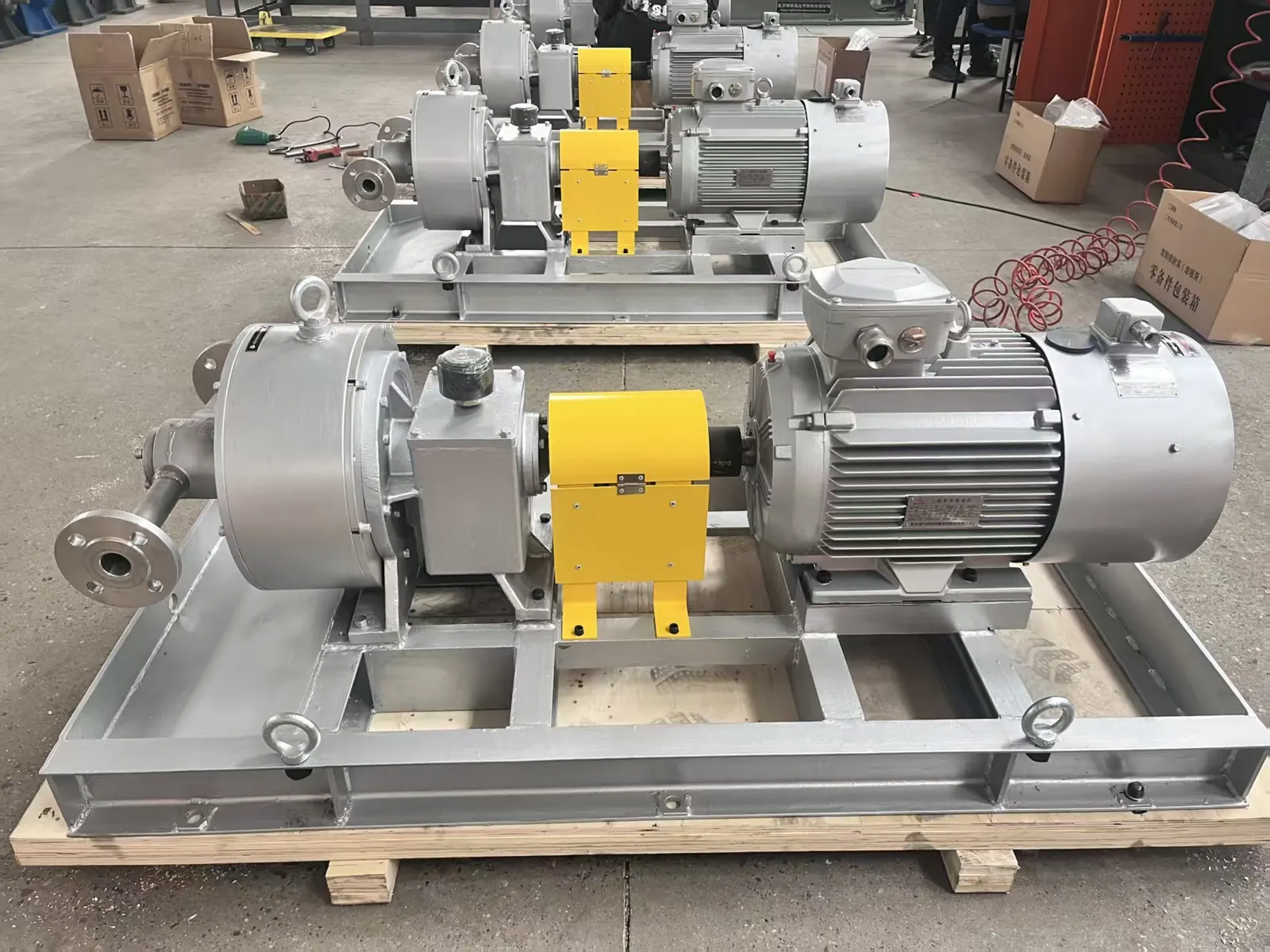 Two EHIK pitot tube pump sets with motors and coupling guards on steel baseplates, ready for dispatch